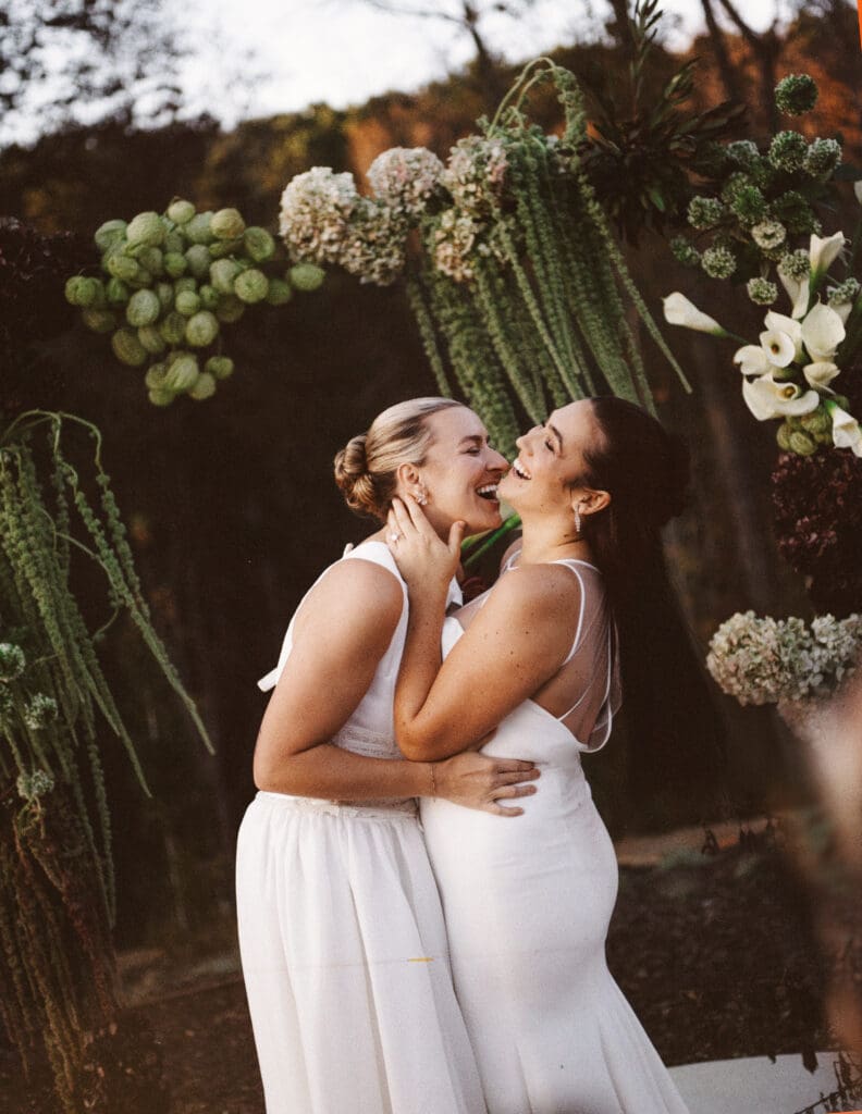 two brides laughing at the skyroom.