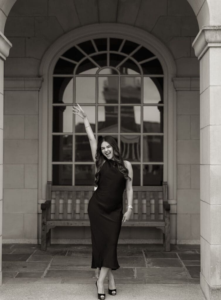 Editorial black and white graduation portrait of Wake Forest senior standing under campus colonnade