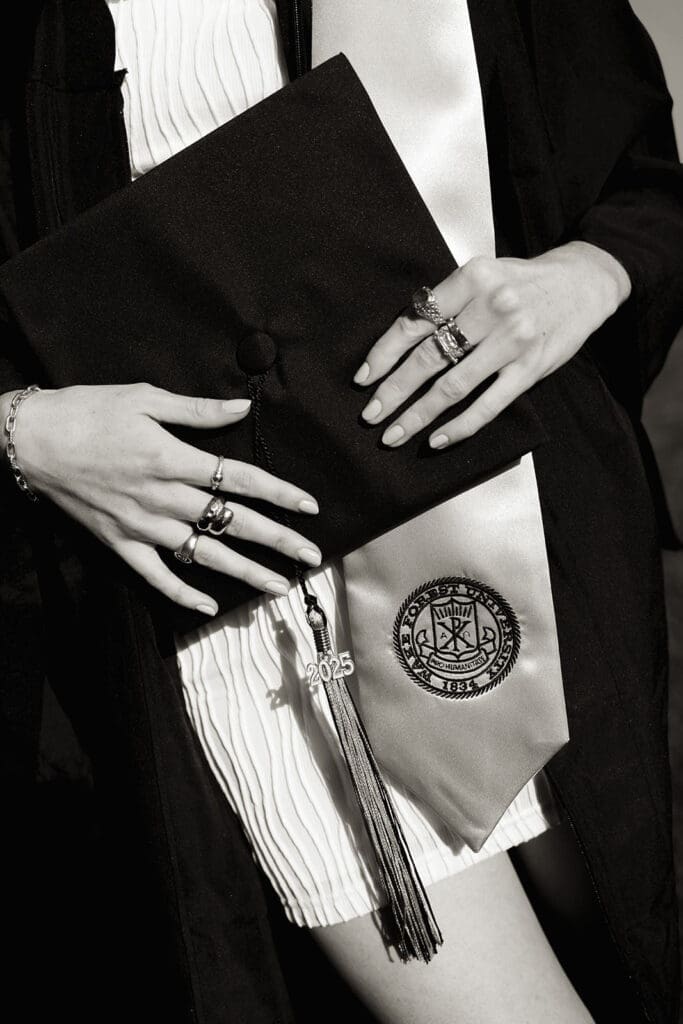 Creative Wake Forest graduation photo featuring grad cap and florals during editorial senior portraits