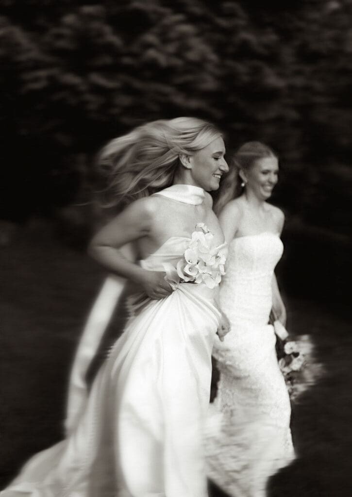 Brides running together during editorial wedding photography at Le Château du Coeur.