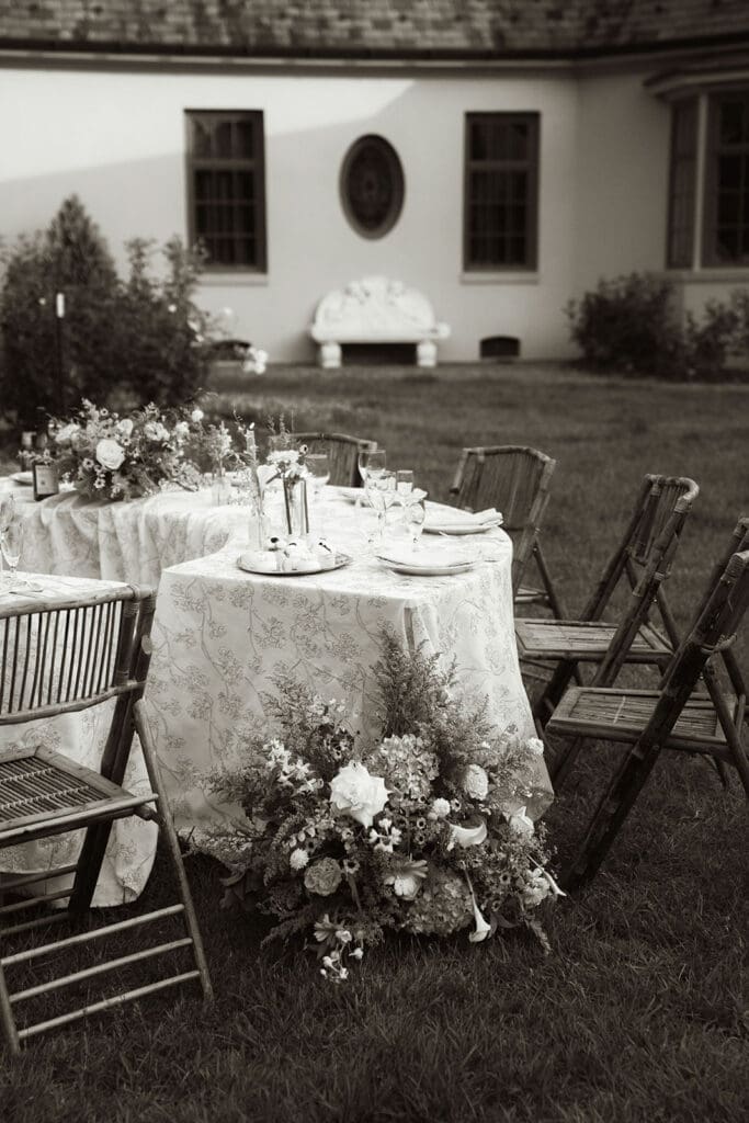 French-inspired wedding reception table with florals at Le Château du Coeur.