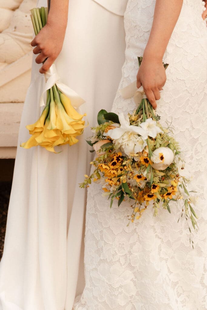 Bridal bouquet with yellow calla lilies and garden flowers.