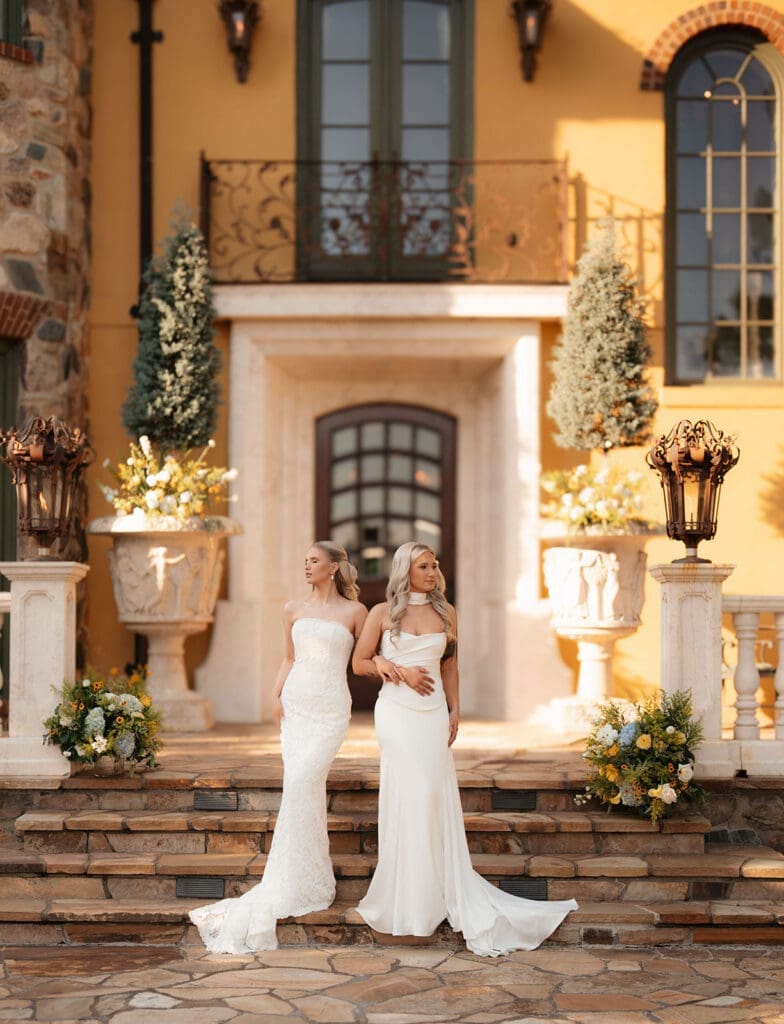 Brides standing in front of Le Château du Coeur during editorial wedding portraits.