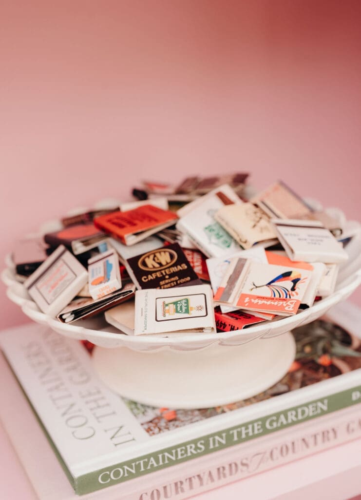 Vintage matchbooks displayed as wedding favors on a reception table.