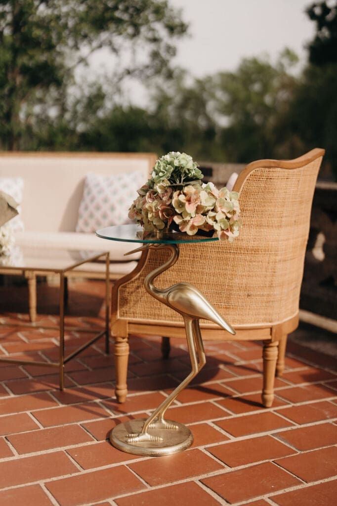 Lounge seating with floral accents for an outdoor Hill House wedding reception.