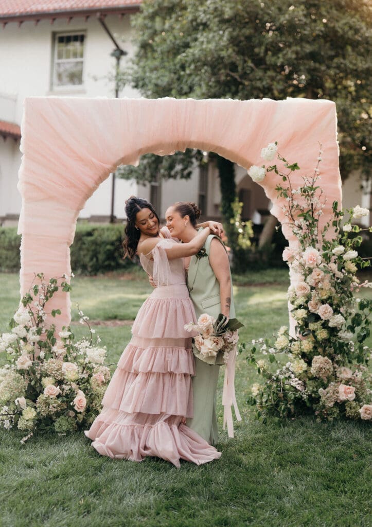 Couple sharing a quiet moment surrounded by garden florals at Hill House.