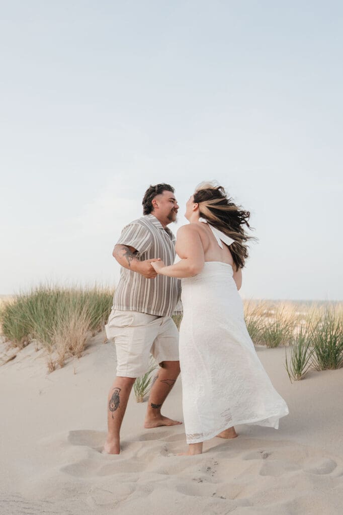 couple facing each other on beach.